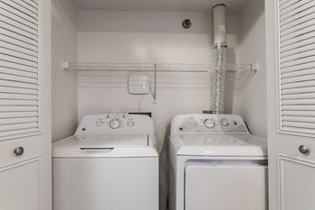 A laundry closet with a washer and dryer